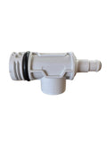 A white plastic plumbing fitting or connector with black rubber O-rings, shown on a brown workbench inside a workshop or shop environment.